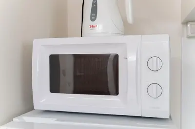 a white microwave with a blender on top of it at Private Apartment HOTEL Ceres Kamiikebukuro 401 in Tokyo