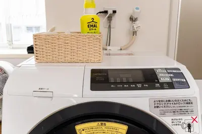 a washing machine with a basket on top of it at Private Apartment HOTEL Ceres Kamiikebukuro 401 in Tokyo
