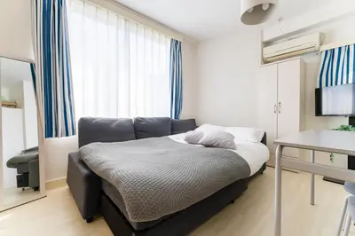 a small bedroom with a bed and a window at Private Apartment HOTEL Ceres Kamiikebukuro 401 in Tokyo