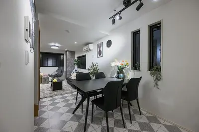 a dining room with a black table and chairs at Skytree View Riverside Terrace in Tokyo