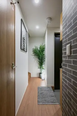 a hallway with a door and a potted plant at Skytree View Riverside Terrace in Tokyo