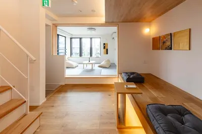 a living room with a couch and a table at HoursHouse HD JAPAN in Tokyo