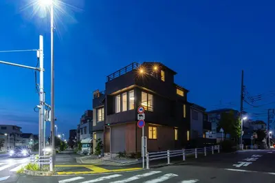 a building with lights on top of it on a street at HoursHouse HD JAPAN in Tokyo