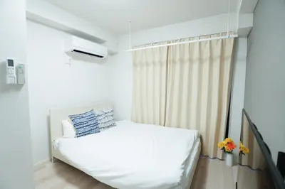 a bedroom with a white bed and a window at \u30b0\u30e9\u30f3\u30b7\u30e3\u30ea\u30aa\u7acb\u82b1 in Tokyo