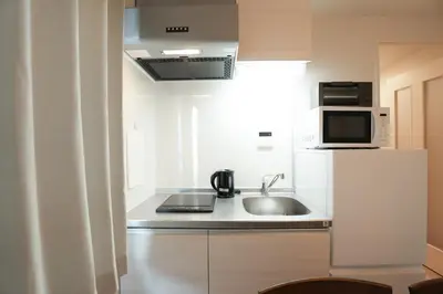 a small kitchen with a sink and a microwave at \u30b0\u30e9\u30f3\u30b7\u30e3\u30ea\u30aa\u7acb\u82b1 in Tokyo