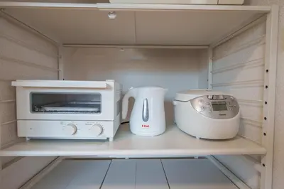a microwave and a toaster on a shelf in a kitchen at INDIGO HOUSE 3-story House, 4BR 8 Beds, Family Friends Welcome - Shinjuku Disney\u6771\u4eac\u30c7\u30a3\u30ba\u30cb\u30fc\u30ea\u30be\u30fc\u30c8 in Tokyo