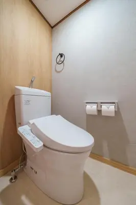 a bathroom with a toilet with a remote control on it at INDIGO HOUSE 3-story House, 4BR 8 Beds, Family Friends Welcome - Shinjuku Disney\u6771\u4eac\u30c7\u30a3\u30ba\u30cb\u30fc\u30ea\u30be\u30fc\u30c8 in Tokyo