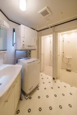 a bathroom with a sink and a washer and dryer at INDIGO HOUSE 3-story House, 4BR 8 Beds, Family Friends Welcome - Shinjuku Disney\u6771\u4eac\u30c7\u30a3\u30ba\u30cb\u30fc\u30ea\u30be\u30fc\u30c8 in Tokyo