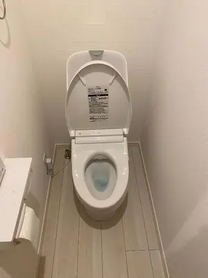 a small bathroom with a toilet with the lid up at Private Yotsugi Prime Direct Access from Haneda & Narita Airports in Tokyo