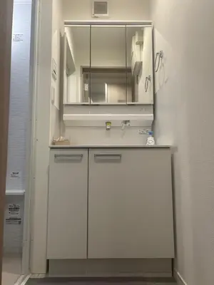 a white bathroom with a sink and a mirror at Private Yotsugi Prime Direct Access from Haneda & Narita Airports in Tokyo