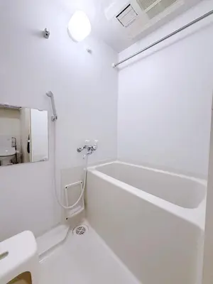 a white bathroom with a tub and a sink at Room with a view of Skytree, close to Kinshicho station in Tokyo