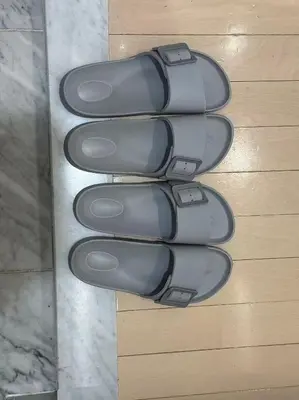 a row of gray shoes sitting on a wall at Room with a view of Skytree, close to Kinshicho station in Tokyo