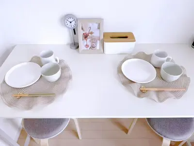 a white table with plates and bowls and a clock at Room with a view of Skytree, close to Kinshicho station in Tokyo