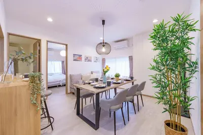 a dining room and living room with a table and chairs at Tany House 1F sky tree 20 minutes, maximum 8 people, 3 bedrooms, new interior in Tokyo
