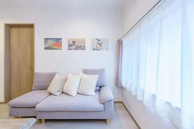 a living room with a couch and a window at Tany House 1F sky tree 20 minutes, maximum 8 people, 3 bedrooms, new interior in Tokyo