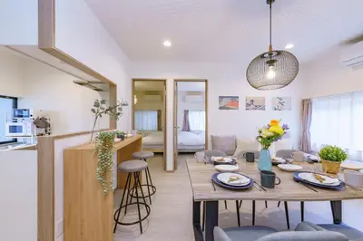 a kitchen and living room with a table and chairs at Tany House 1F sky tree 20 minutes, maximum 8 people, 3 bedrooms, new interior in Tokyo
