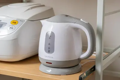 a white appliance sitting on a shelf next to a toaster at Tany House 1F sky tree 20 minutes, maximum 8 people, 3 bedrooms, new interior in Tokyo