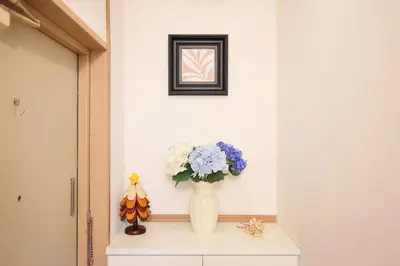 a vase with flowers sitting on a table in a hallway at 3 min JR Near Tokyo Skytree Asakusa Shinjuku Sea Heim in Tokyo
