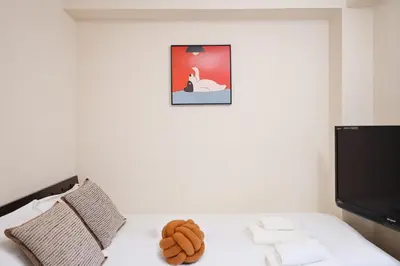 a room with a bed with a teddy bear on it at 3 min JR Near Tokyo Skytree Asakusa Shinjuku Sea Heim in Tokyo