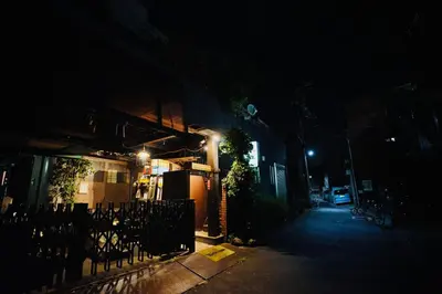 a street at night with a building with lights at MUSICIAN AIR 0014 kyojima in Tokyo