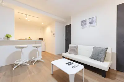 a living room with a white couch and a table at konomi \u4e8c\u5341\u4e8c\u756a\u9928 \u83ca\u5ddd\u5f92\u6b693\u5206 in Tokyo