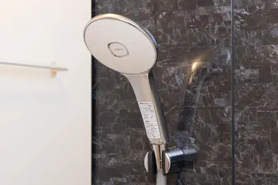 a magnifying mirror is hanging on a wall at konomi \u4e8c\u5341\u4e8c\u756a\u9928 \u83ca\u5ddd\u5f92\u6b693\u5206 in Tokyo