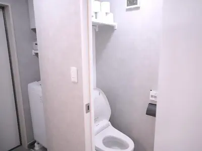 a small bathroom with a toilet in a stall at Near Asakusa, Projector, Twin and Semi Double Rooms in Tokyo