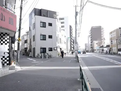 a person riding a bike down a city street at Near Asakusa, Projector, Twin and Semi Double Rooms in Tokyo