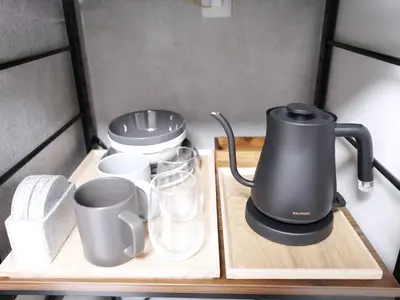 a tea kettle and cups on a wooden tray at Near Asakusa, Projector, Twin and Semi Double Rooms in Tokyo