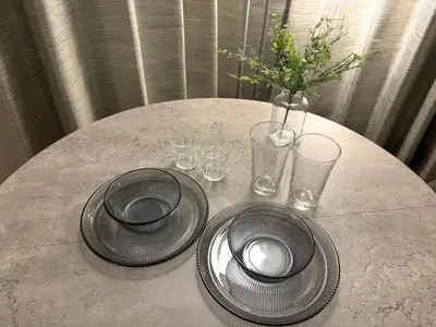 a table with two plates and glasses and a vase at FARE Akihabara - Stylish Premium Studio 8min from Station 202 in Tokyo