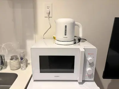 a microwave with a coffee maker on top of it at FARE Akihabara - Stylish Premium Studio 8min from Station 202 in Tokyo