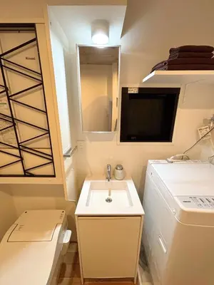 a small bathroom with a sink and a mirror at FARE Akihabara - Stylish Premium Studio 8min from Station 202 in Tokyo