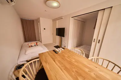 a living room with a wooden table and a couch at Serendipity Asakusa in Tokyo
