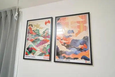 two framed posters on a wall in a room at Serendipity Asakusa in Tokyo