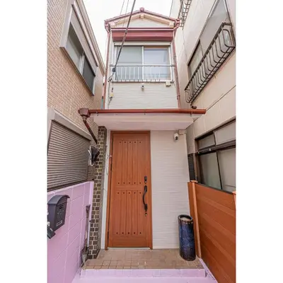 a house with a wooden door and a balcony at Sky Tree Stay Hotel 5 8-minute walk from Yahiro Station 3-minute train ride to Tokyo Skytree Station in Tokyo