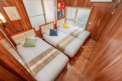 two beds in a room with wood walls at Sky Tree Stay Hotel 5 8-minute walk from Yahiro Station 3-minute train ride to Tokyo Skytree Station in Tokyo