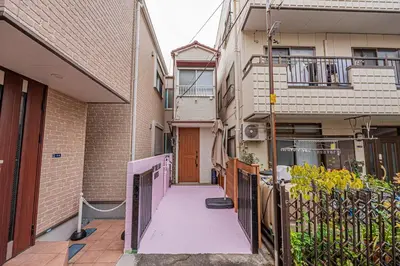 an alley between two buildings with a gate and a door at Sky Tree Stay Hotel 5 8-minute walk from Yahiro Station 3-minute train ride to Tokyo Skytree Station in Tokyo