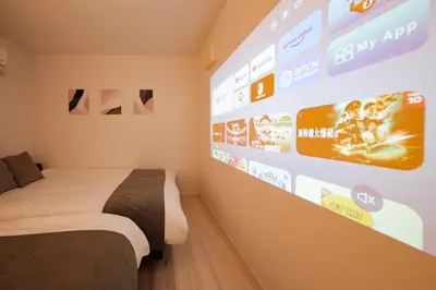 a room with two beds and a wall with signs at MIKASA guesthouse3 in Tokyo