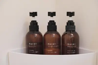 three bottles of hairologne sitting on a white shelf at MIKASA guesthouse3 in Tokyo