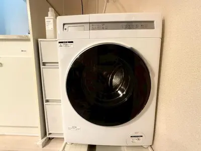 a white washing machine sitting in a kitchen at MIKASA guesthouse3 in Tokyo