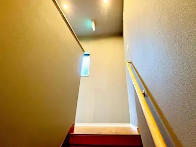 a hallway with a stairway leading up to a room at \u6e0b\u8c37\u611b\u306e\u6cca in Tokyo