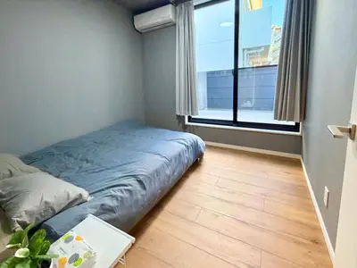 a bedroom with a bed and a large window at \u6e0b\u8c37\u611b\u306e\u6cca in Tokyo
