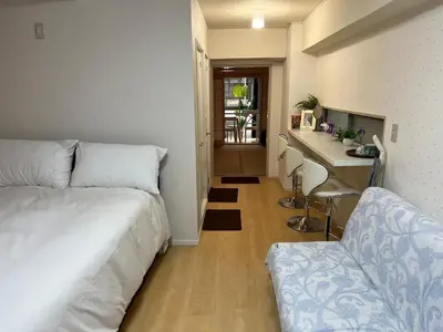 a bedroom with a bed and a desk and a kitchen at \u6771\u65b0\u5bbf\u30a8\u30ea\u30a2772 in Tokyo