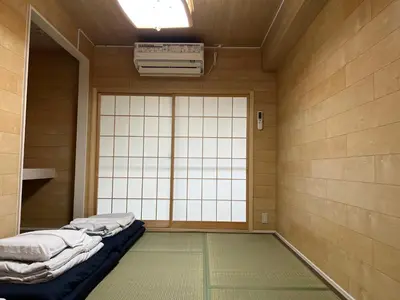 a room with a large window and a bed in front of it at \u6771\u65b0\u5bbf\u30a8\u30ea\u30a2772 in Tokyo