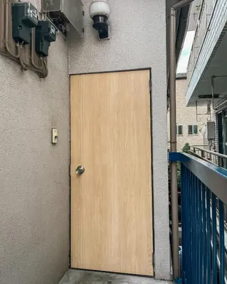 a wooden door on the side of a building at Hostel Hana An in Tokyo