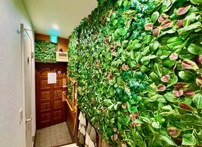 a wall covered in green plants in a hallway at Shimbashi,3BR,2Baths,8ppl in Tokyo