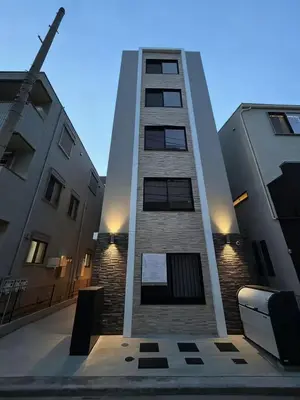 a tall building with lights on the side of it at Home Story in Tokyo Aerial大島&東京屋 in Tokyo