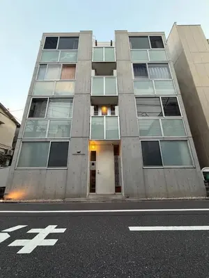 a tallartment building on a city street with a road at 301Room,7-minute walk from Uguisudani Station located on the 3nd floor of an apartment-style building Twin room No elevator in Tokyo