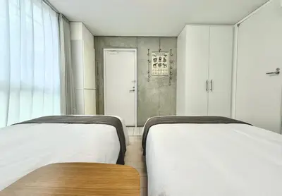 two beds sitting next to each other in a room at 101Room,7-minute walk from Uguisudani Station located on the 1nd floor of an apartment-style building Twin room No elevator in Tokyo