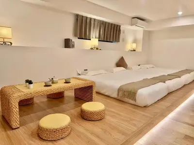 a hotel room with a large bed and a table at ISSHUKU Noma \u5317\u65b0\u5bbf -101 Multiple Beds Room 4-6 Guests in Tokyo
